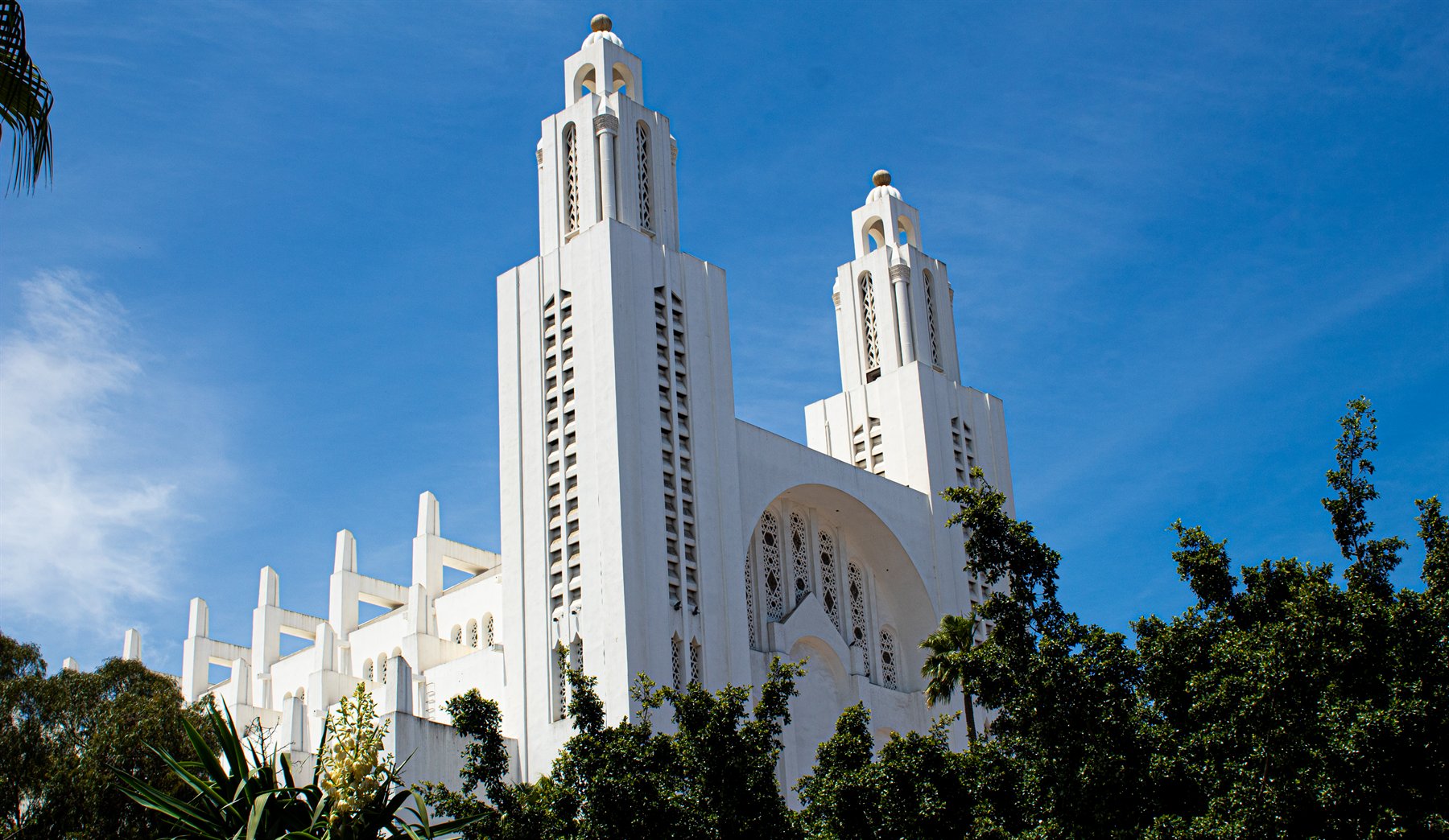 White twin towers against a deep blue sky
